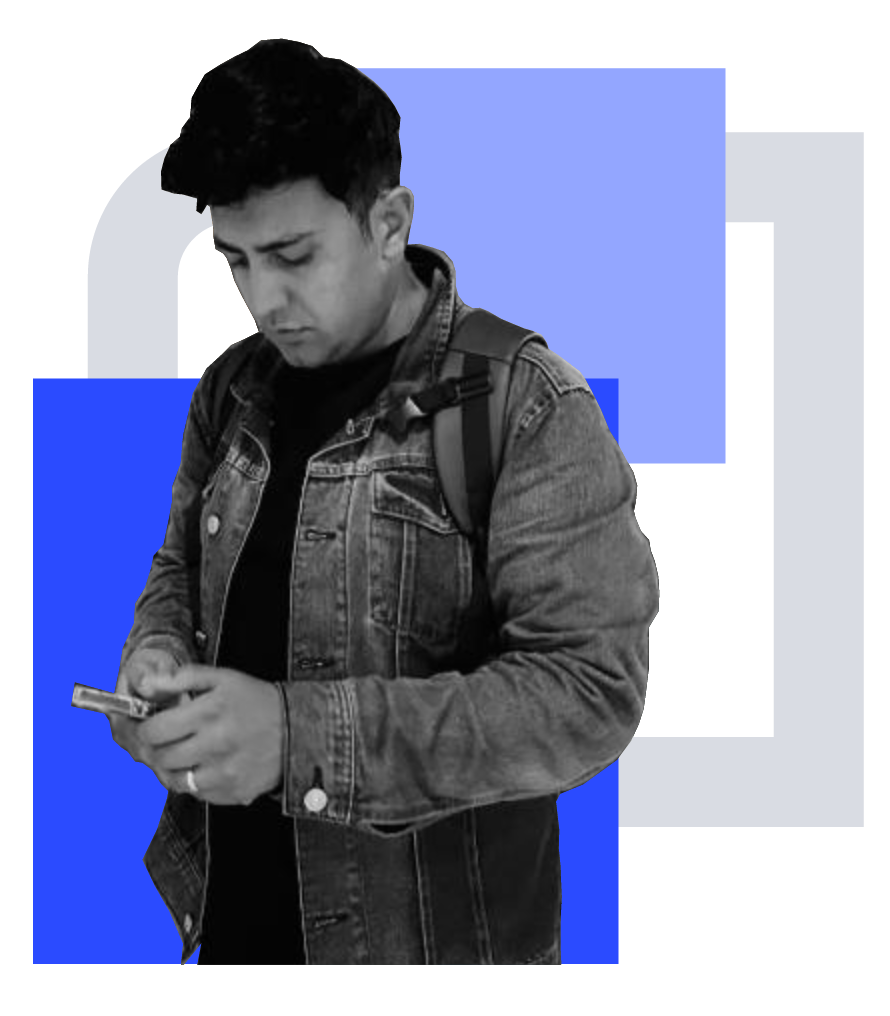 Esam in a denim jacket, looking down at his phone, in front of blue and grey shapes